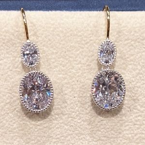 Oval Cubic Zirconia French-Wire Drop Earrings. Gold and Rhodium plated silver.